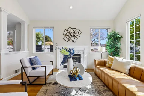 a living room with furniture and a potted plant