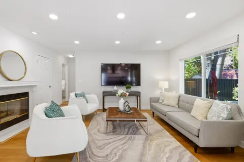 a living room with furniture fireplace and window