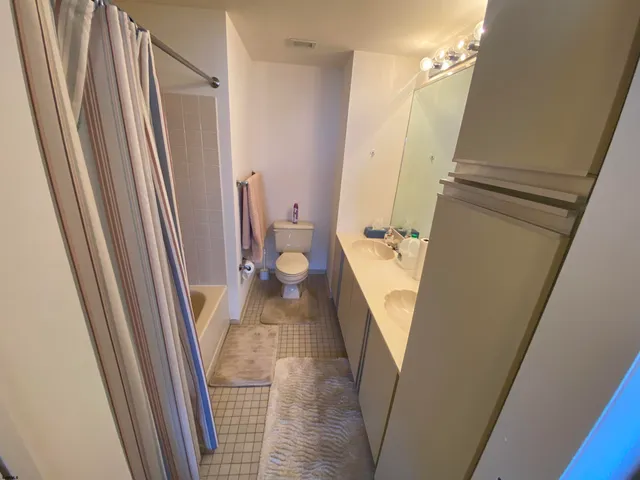 a view of a hallway with wooden floor and stairs