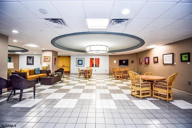 a living room with furniture and dining table