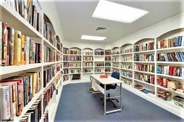 a reading room with furniture book shelf and a book shelf