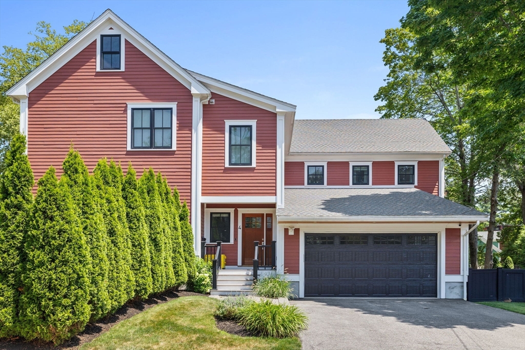 4 Coyne Road, Unit 4 Newton, MA 02468 - Photo 1 of 18 a front view of a house with a yard and garage
