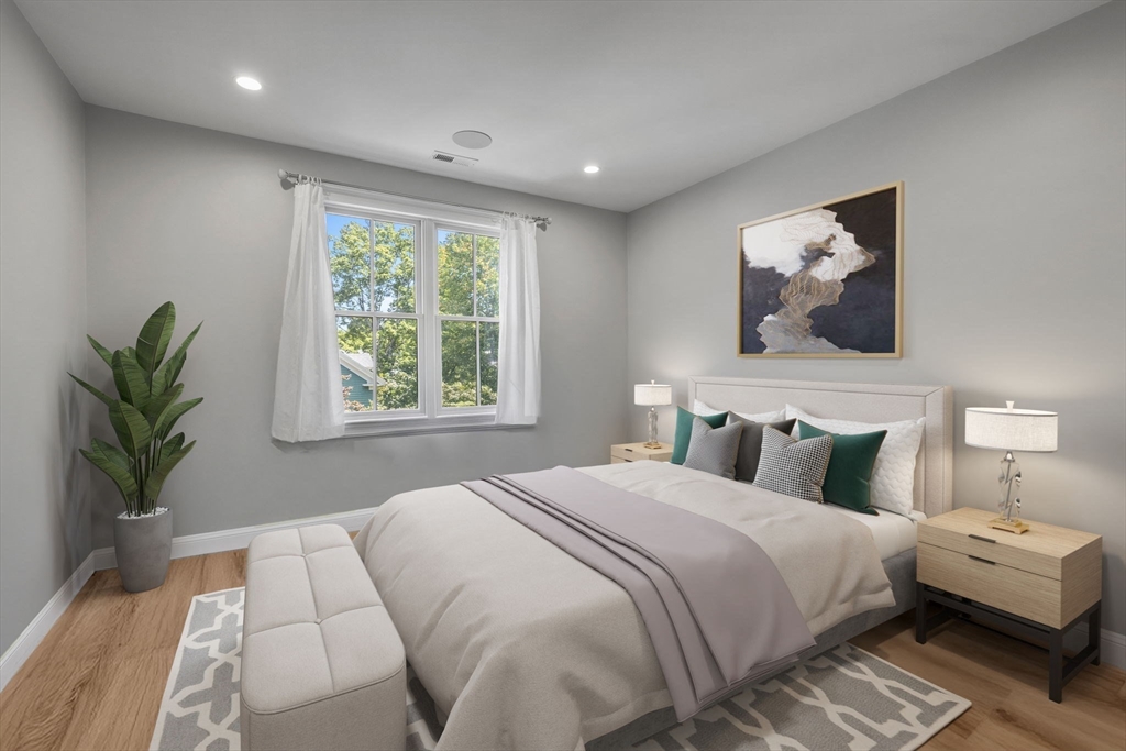 4 Coyne Road, Unit 4 Newton, MA 02468 - Photo 11 of 18 a bedroom with a large bed and a potted plant