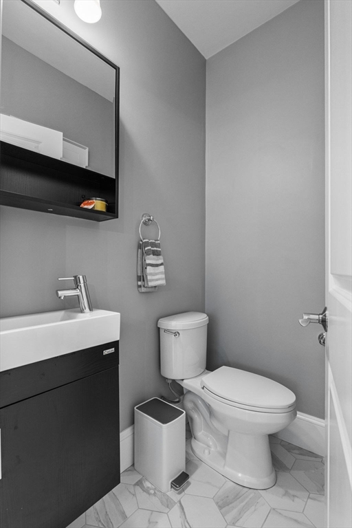 4 Coyne Road, Unit 4 Newton, MA 02468 - Photo 12 of 18 a bathroom with a toilet a sink and mirror