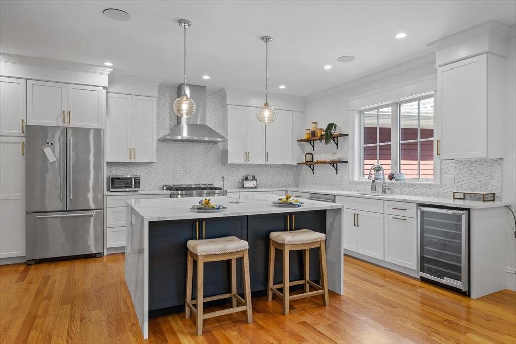 4 Coyne Road, Unit 4 Newton, MA 02468 - Photo 2 of 18 a kitchen with kitchen island granite countertop a sink a center island and stainless steel appliances