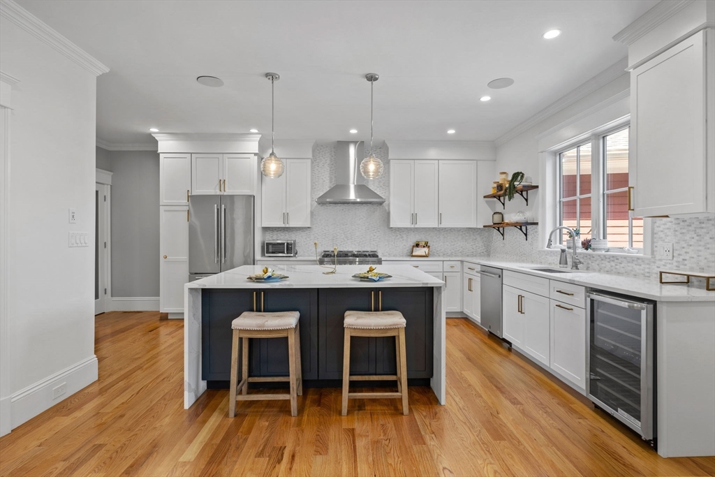 4 Coyne Road, Unit 4 Newton, MA 02468 - Photo 3 of 18 a kitchen with kitchen island granite countertop a sink and wooden cabinets