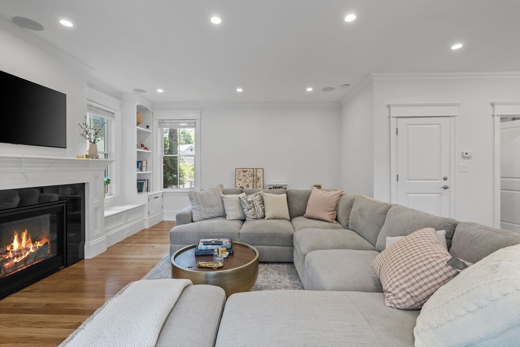 4 Coyne Road, Unit 4 Newton, MA 02468 - Photo 5 of 18 a living room with furniture a flat screen tv and a fireplace