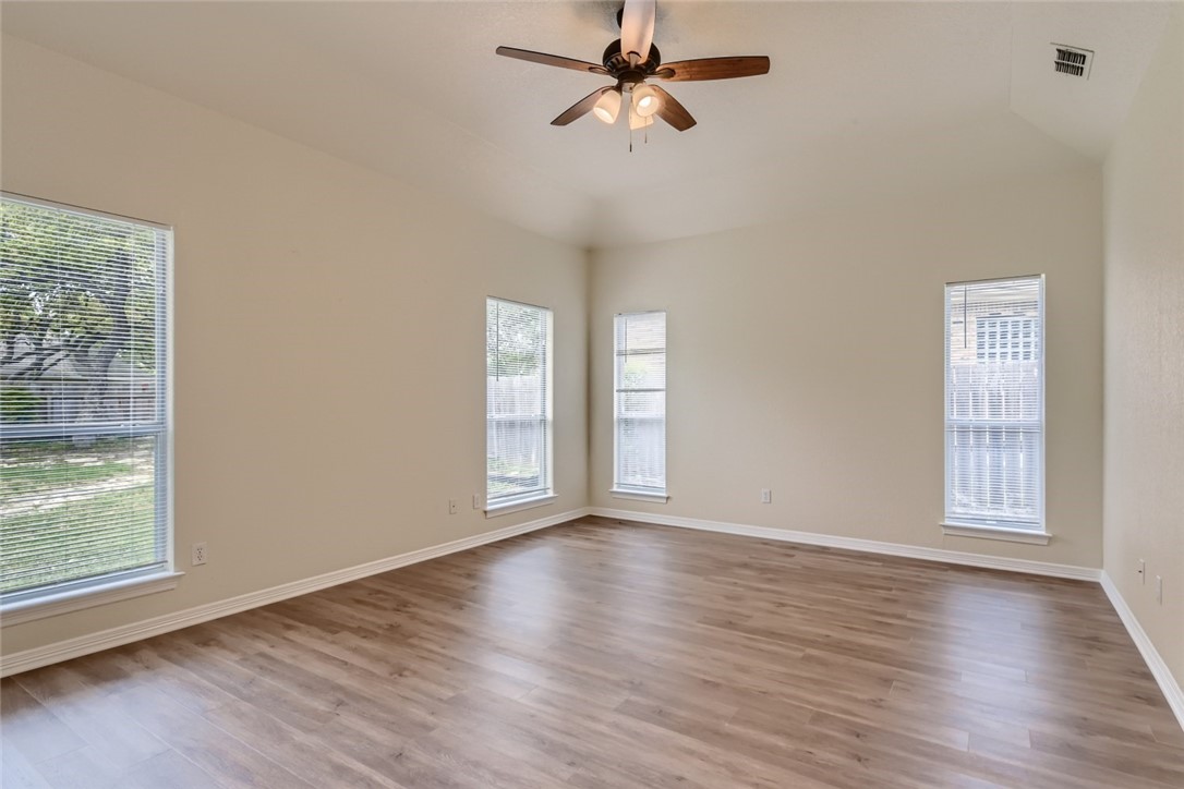 511 Susana Drive Georgetown, TX 78628 - Photo 16 of 31 Spacious primary bedroom featuring vinyal plank flooring and ceiling fan