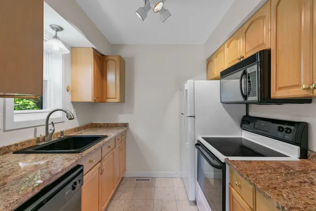 a kitchen that has a sink and a stove