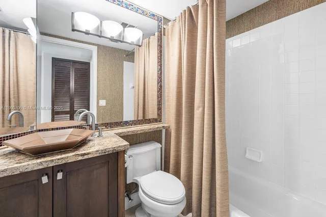 a bed room with a bed and a chandelier