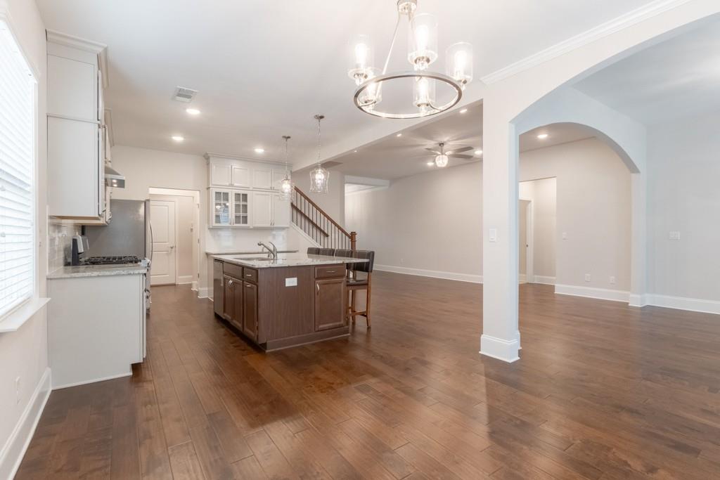 601 Cork Street Woodstock, GA 30188 - Photo 11 of 52 a kitchen with stainless steel appliances kitchen island granite countertop a refrigerator and a stove top oven
