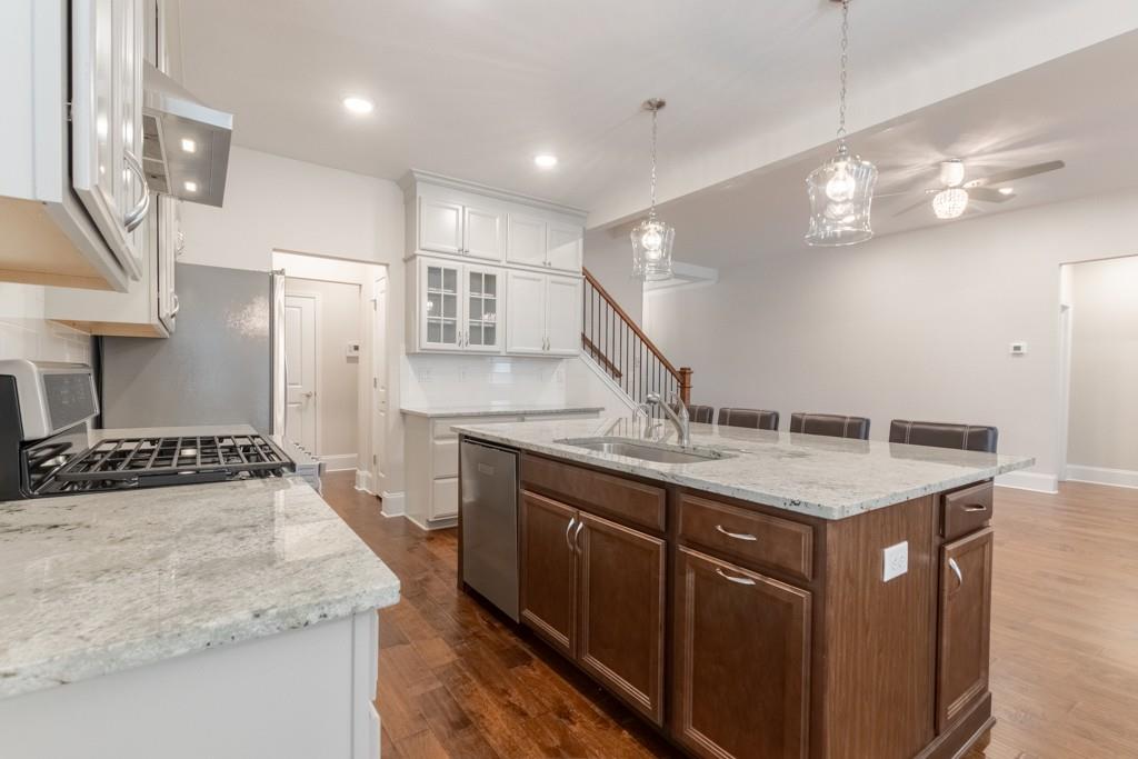 601 Cork Street Woodstock, GA 30188 - Photo 12 of 52 a kitchen with stainless steel appliances granite countertop a sink a stove and a refrigerator