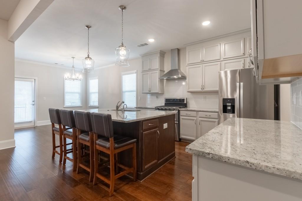601 Cork Street Woodstock, GA 30188 - Photo 16 of 52 a large kitchen with a table and chairs