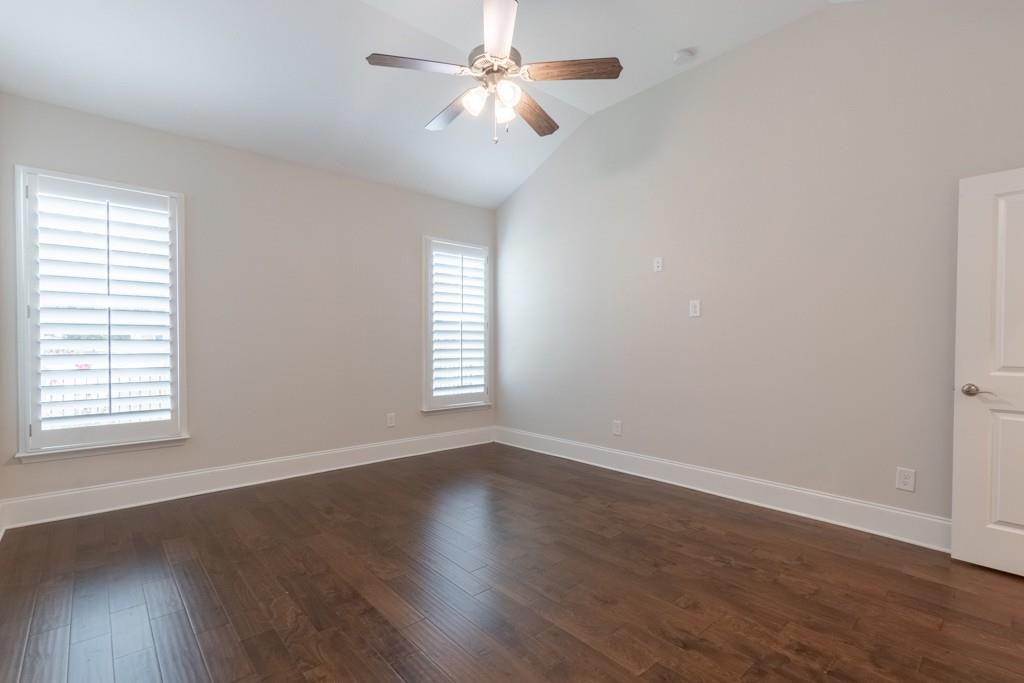 601 Cork Street Woodstock, GA 30188 - Photo 25 of 52 an empty room with wooden floor ceiling fan and windows