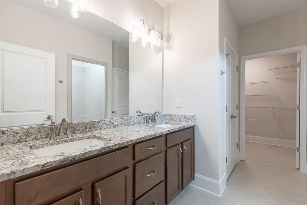 601 Cork Street Woodstock, GA 30188 - Photo 26 of 52 a bathroom with a granite countertop sink and a mirror