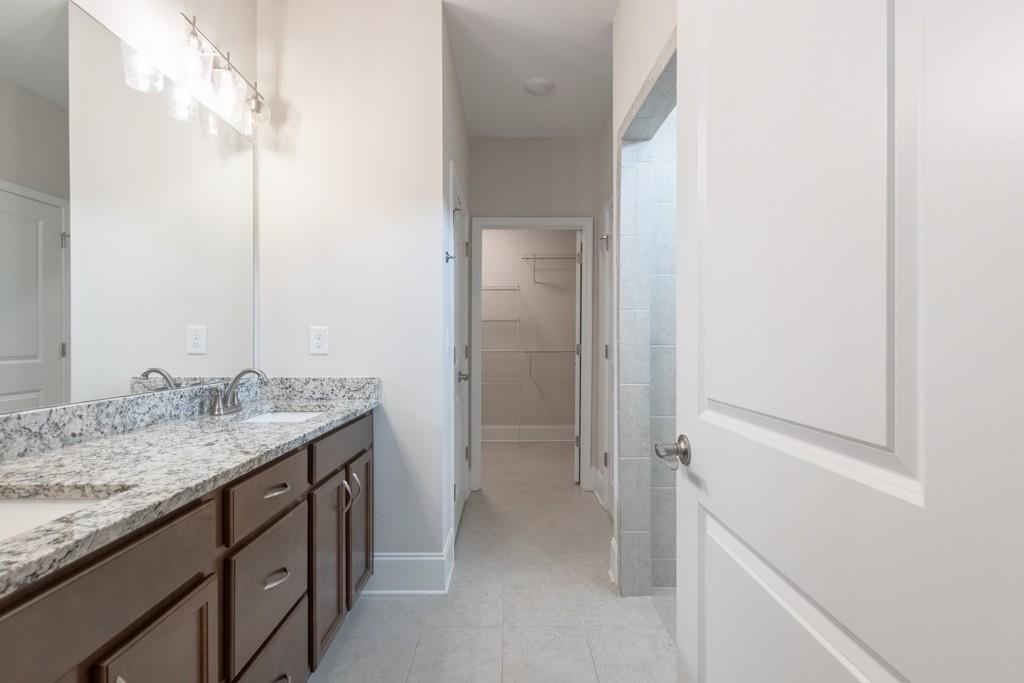601 Cork Street Woodstock, GA 30188 - Photo 27 of 52 a bathroom with a granite countertop sink and a mirror