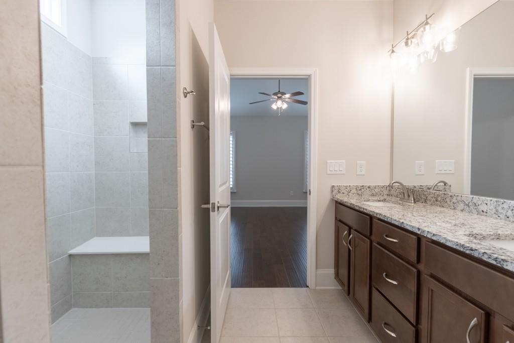 601 Cork Street Woodstock, GA 30188 - Photo 28 of 52 a bathroom with a granite countertop sink and a mirror