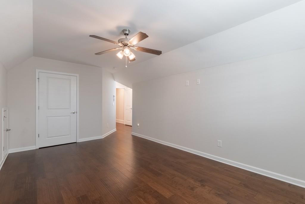601 Cork Street Woodstock, GA 30188 - Photo 40 of 52 an empty room with wooden floor fan and windows