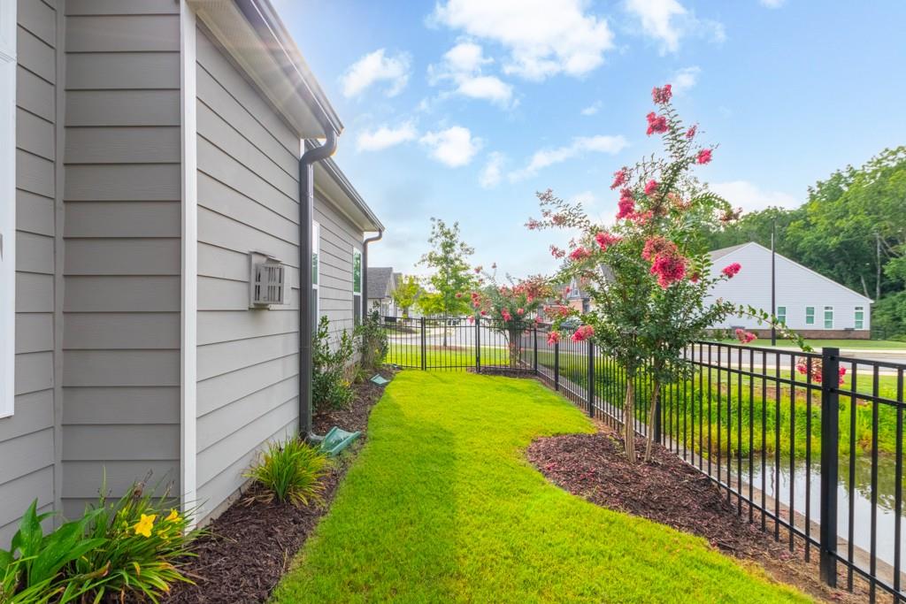601 Cork Street Woodstock, GA 30188 - Photo 45 of 52 a view of a house with a flower garden