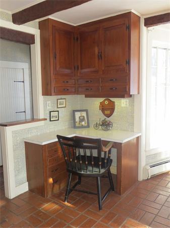 151 Edgell Road Framingham, MA 01701 - Photo 11 of 27 a kitchen with a wooden table and chairs
