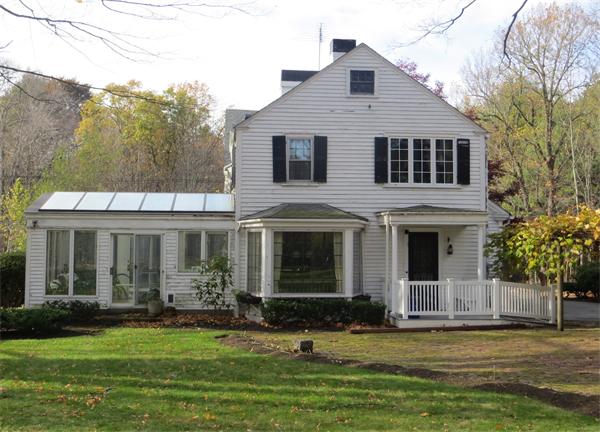 151 Edgell Road Framingham, MA 01701 - Photo 6 of 27 a front view of a house with a garden and trees