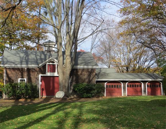151 Edgell Road Framingham, MA 01701 - Photo 8 of 27 a view of a yard in front of a brick house with large windows