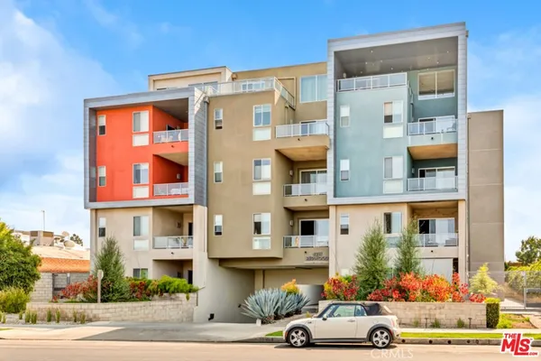 a front view of a building and car parked