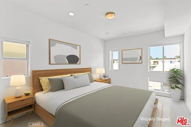 a bedroom with a bed and painting on the wall