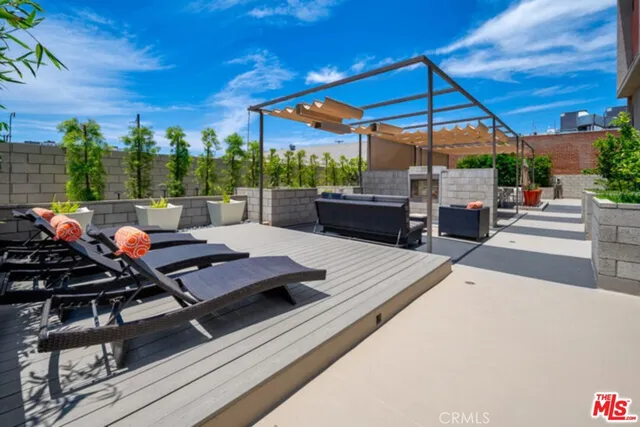 a view of a patio with table and chairs under an umbrella