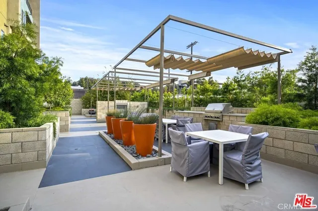 a view of a patio with a table and chairs