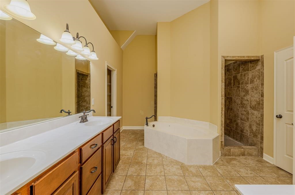 5380 Scarlet Ridge Drive Arlington, TN 38002 - Photo 16 of 35 Bathroom featuring a double vanity with wood cabinetry, a large mirror, and an overhead light fixture
