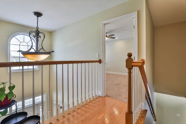 a view of staircase with railing and wooden floor