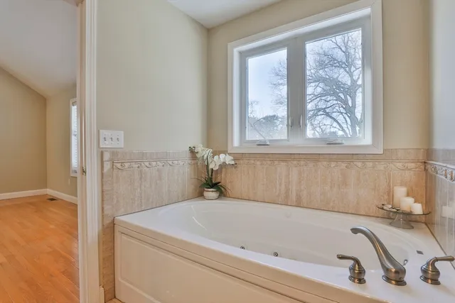 a white bath tub sitting next to a window