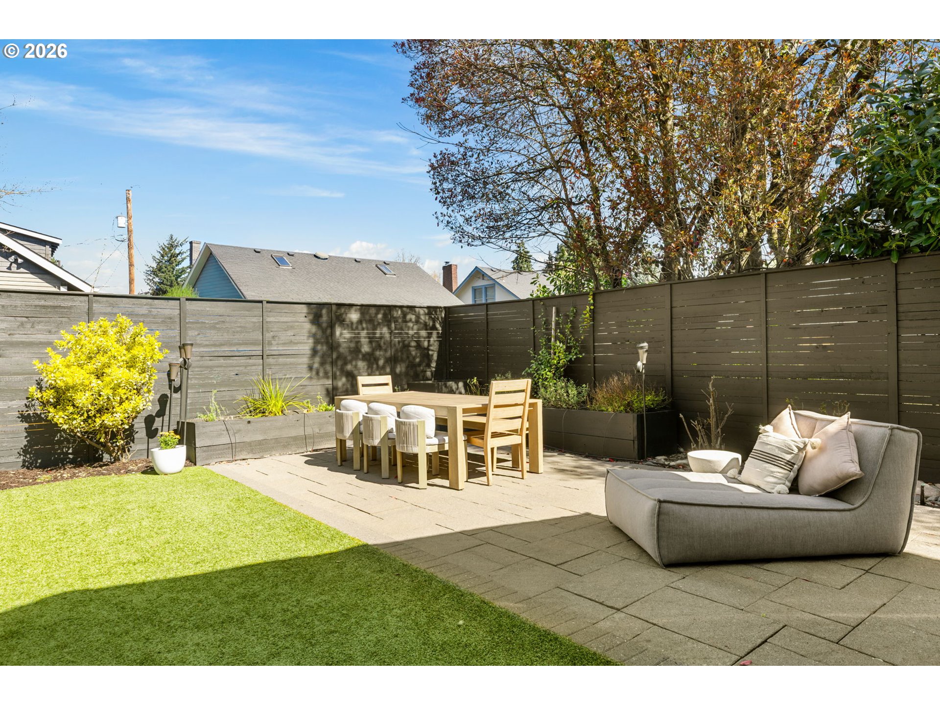 2025 North Alberta Street Portland, OR 97217 - Photo 45 of 48 a view of a patio with couches potted plants and large tree