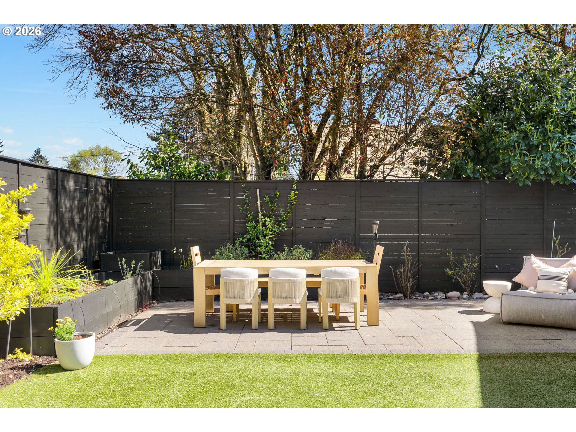 2025 North Alberta Street Portland, OR 97217 - Photo 46 of 48 a view of a patio with table and chairs potted plants and large tree