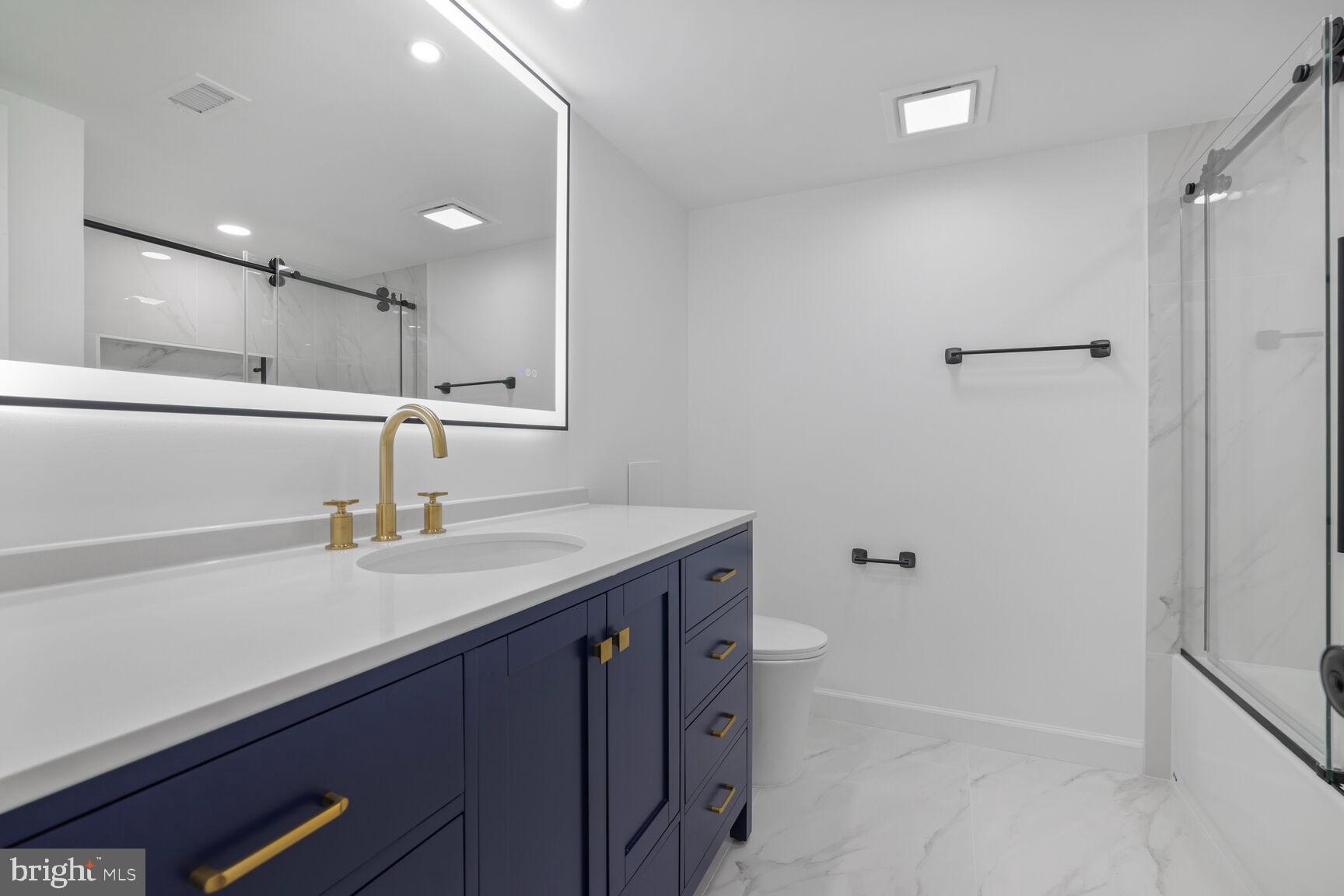 4550 North Park Avenue, Unit 707 Chevy Chase, MD 20815 - Photo 11 of 15 a bathroom with a sink a toilet and shower