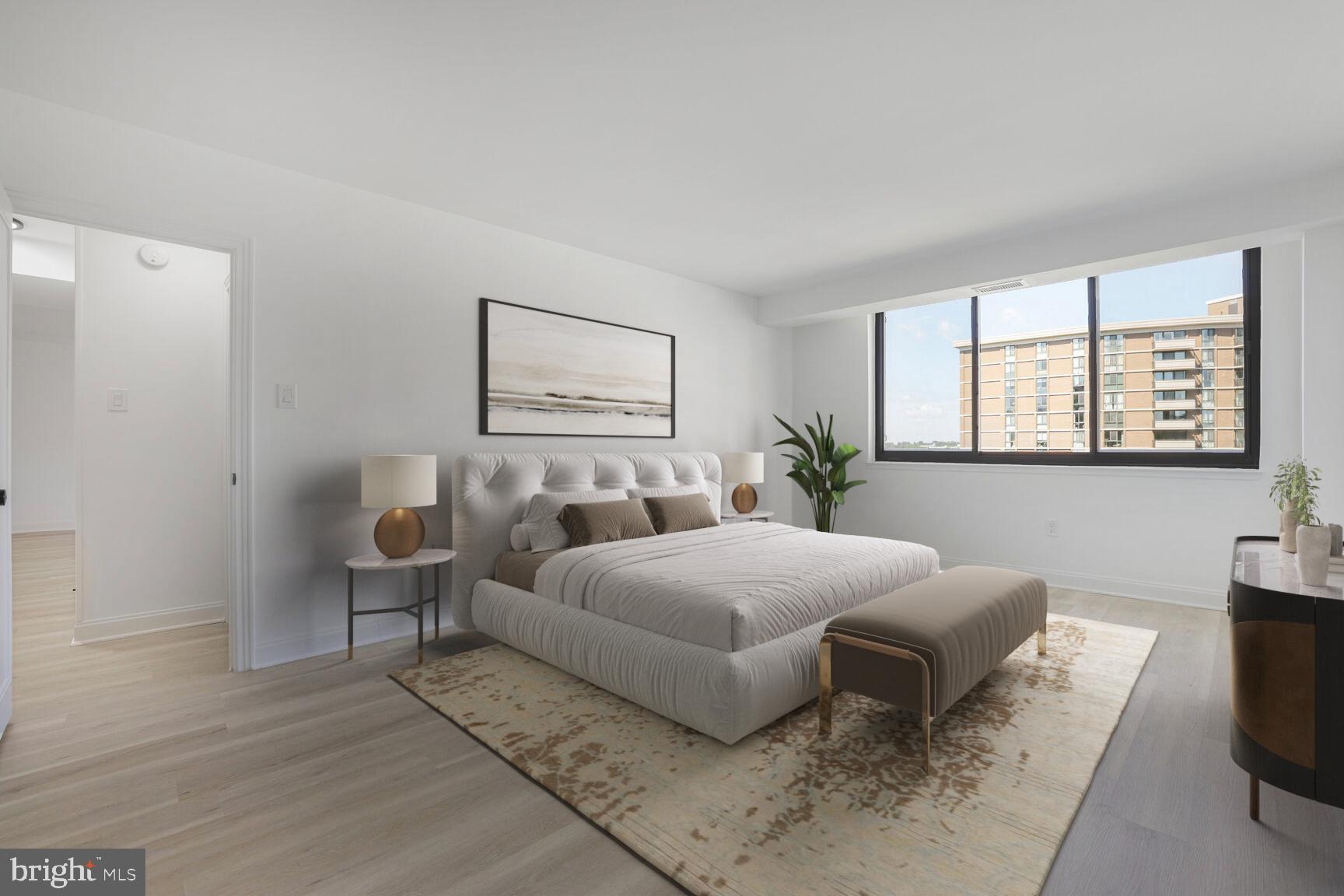 4550 North Park Avenue, Unit 707 Chevy Chase, MD 20815 - Photo 7 of 15 a bedroom with a bed and wooden floor