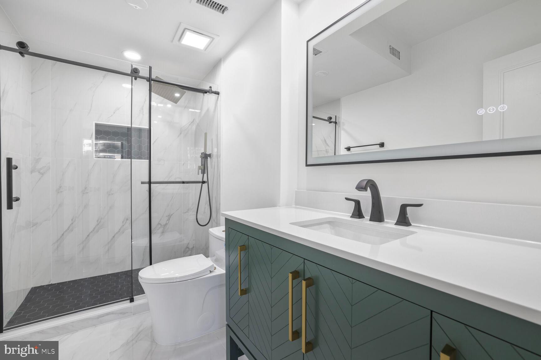 4550 North Park Avenue, Unit 707 Chevy Chase, MD 20815 - Photo 8 of 15 a bathroom with a granite countertop sink toilet and shower