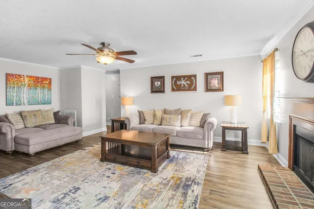 a living room with furniture a fireplace and a chandelier