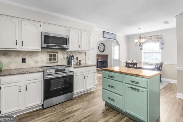 a kitchen with cabinets a stove and a sink