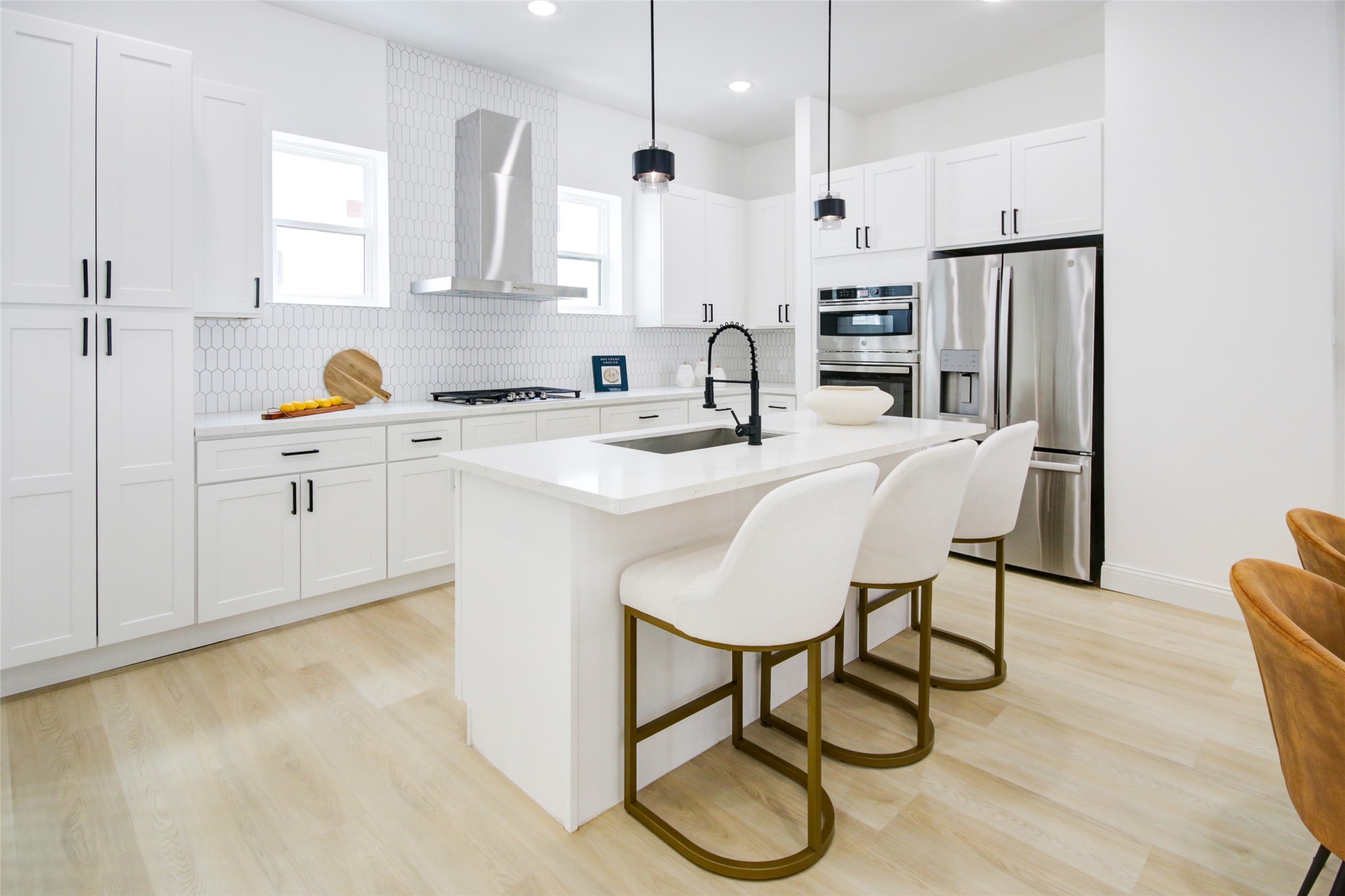 1214 West 24th Street, Unit D Houston, TX 77008 - Photo 10 of 45 a kitchen with stainless steel appliances granite countertop a sink a stove a refrigerator cabinets a dining table and chairs