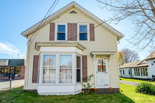a front view of a house with a yard