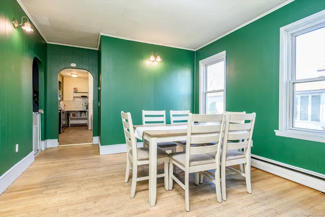 a dining room with furniture and window