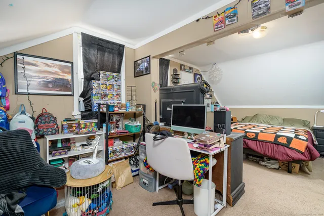 a reading room with furniture and a wooden floor