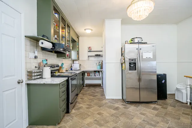 a kitchen with stainless steel appliances granite countertop a refrigerator a sink and a stove