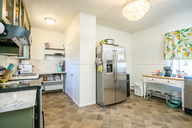 a kitchen with stainless steel appliances granite countertop a refrigerator and a stove