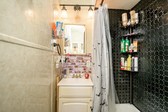 a bathroom with a sink and mirror with toilet