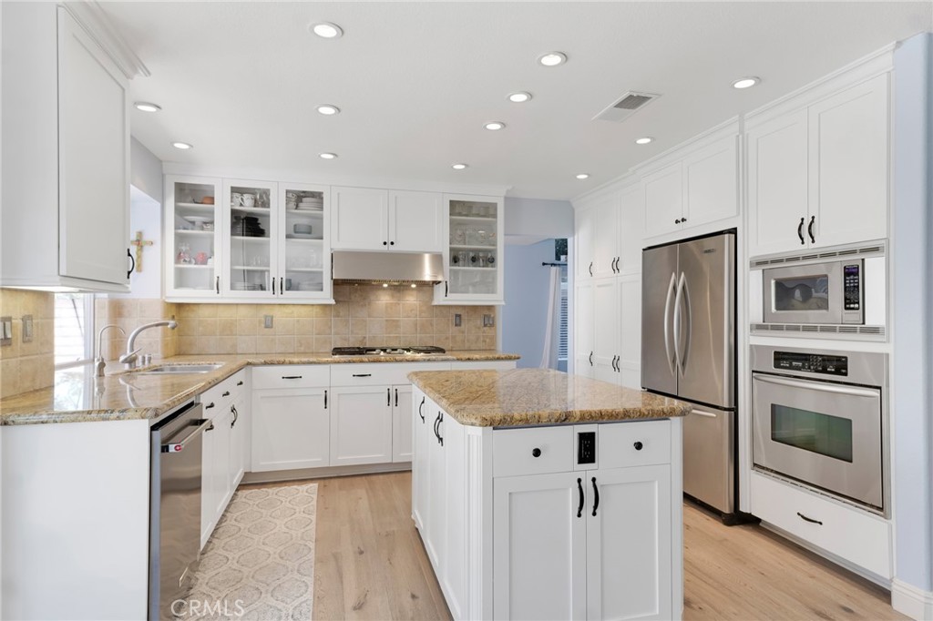 3843 San Gabriel Street Simi Valley, CA 93063 - Photo 19 of 52 a kitchen with stainless steel appliances granite countertop a sink and a stove