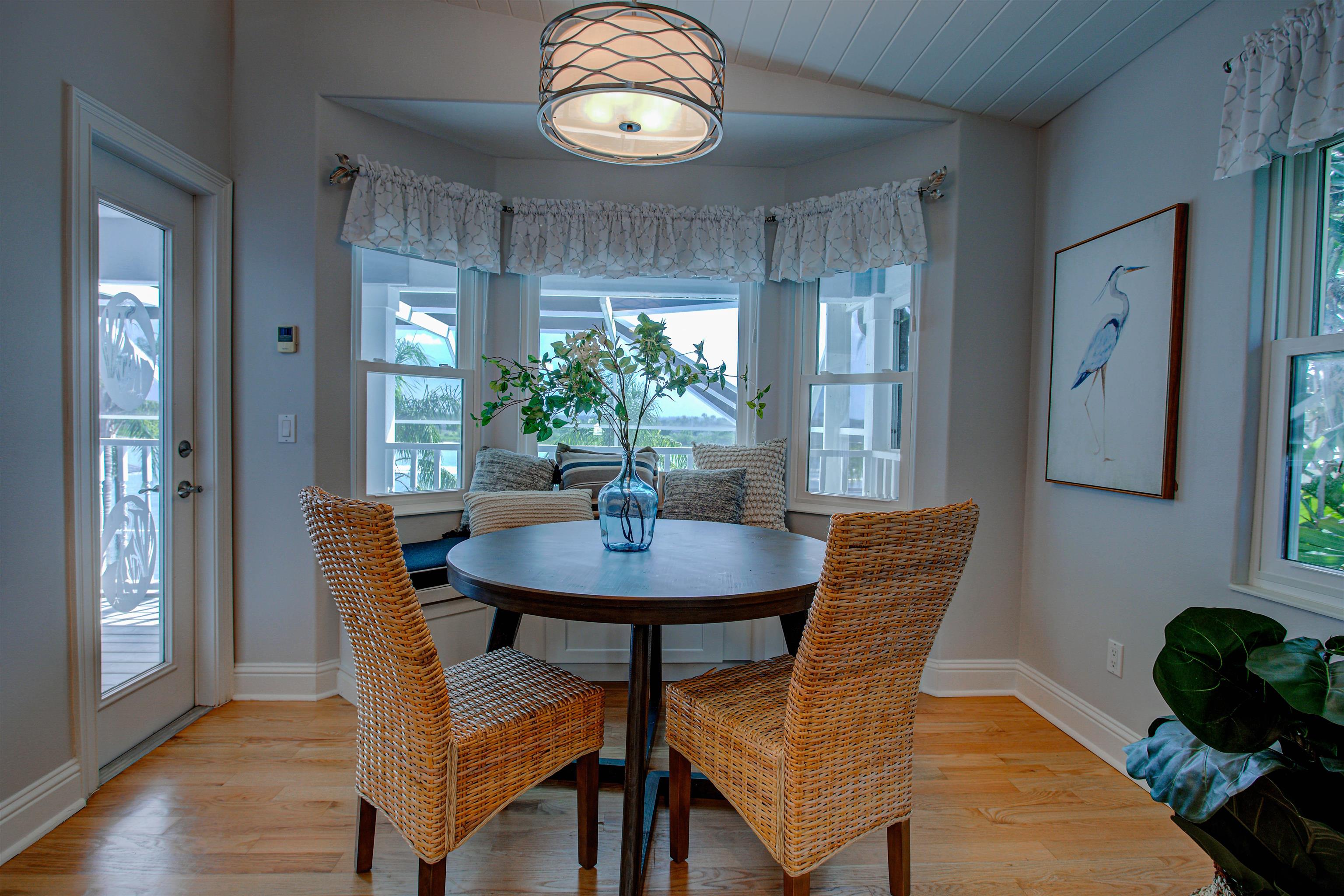 9151 June Lane St. Augustine, FL 32080 - Photo 11 of 73 a view of a dining room with furniture and wooden floor