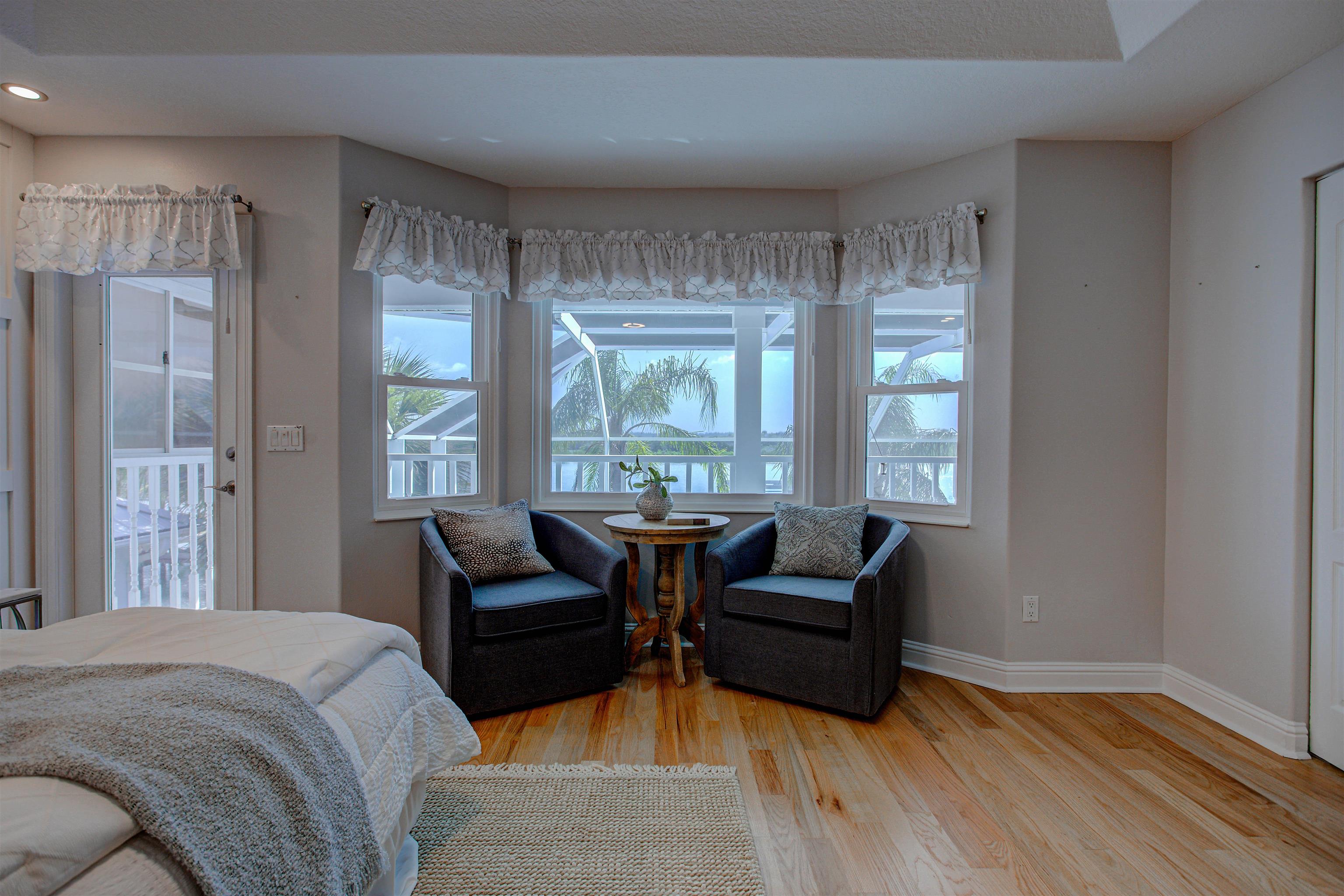 9151 June Lane St. Augustine, FL 32080 - Photo 30 of 73 a living room with furniture and two large window